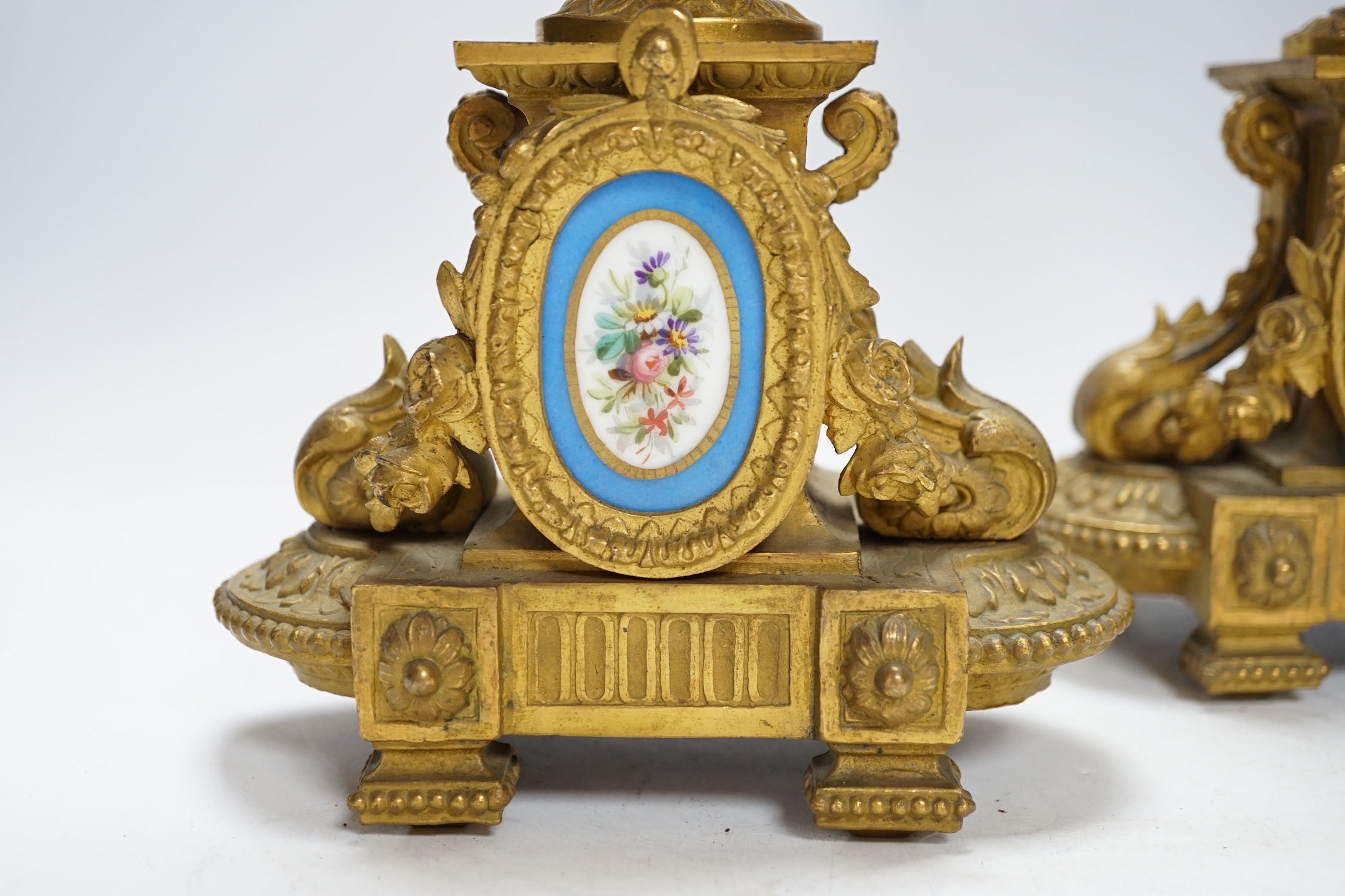 A pair of 19th century French ornamental gilt metal candlesticks, possibly clock garnitures, 32.5cm high